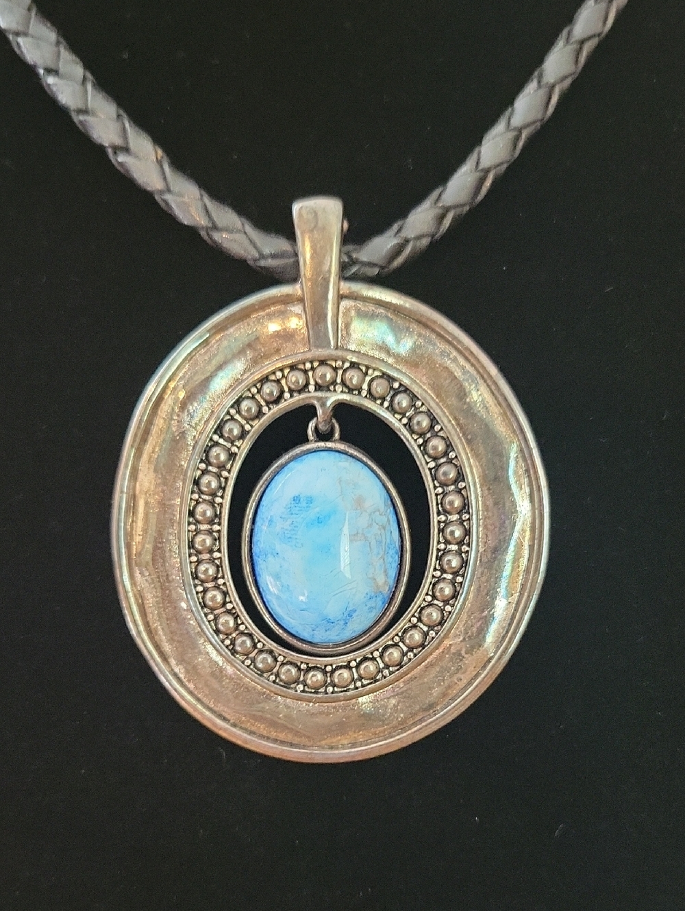 Braided Necklace with Round Silver Pendant w/ Light Blue Colored Stone Premier?